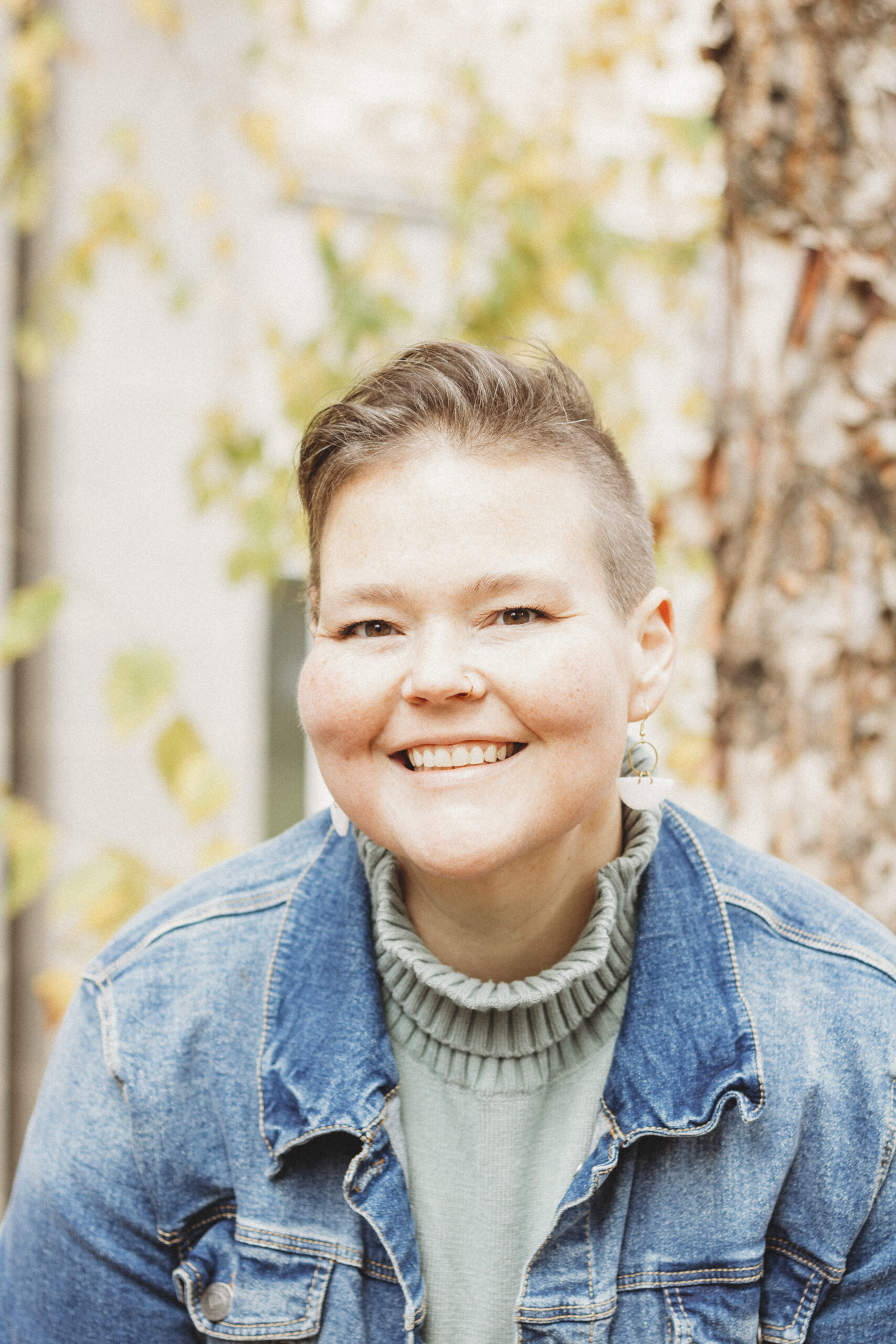 Headshot of a white woman with short brown hair smiling.